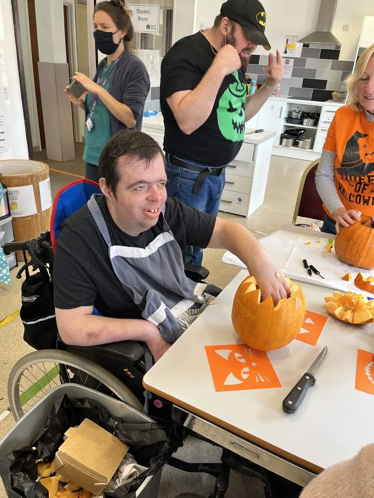 Carving pumpkins together at a community day
