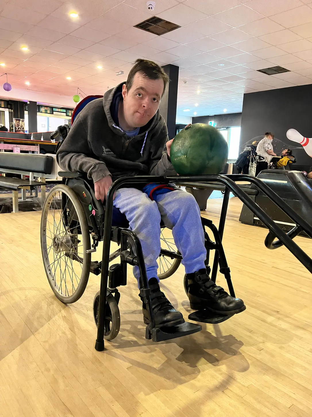 Client holding a bowling ball, ready to roll